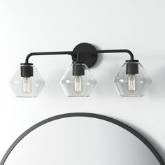 A smooth blend of rustic + industrial, this vanity light’s three clear glass shades showcase striking hexagonal silhouettes. It’s built from steel, and suitable for damp locations, like a bathroom. Install it with a dimmer switch to easily set the vibe in your space. AllModern Finish: Midnight Black, Shade Color: Clear AllModern Rooks 3 - Light Dimmable Vanity Light in Midnight Black/Clear | Size 10.25" H X 26" W X 8.5" D Industrial Farmhouse Lighting, Modern Vanity Lighting, Rental Kitchen, Powder Bath, Farmhouse Lighting, Rustic Industrial, Modern Sculpture, Midnight Black, Vanity Light