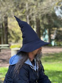 Wizard/Witch hats are made with premium Wool Felt on the outside and Wool Felt or cotton on the under brim. Each hat has unique hand-stitched crooks and quirks and comes with a removable insert filled with polyester fill for lightweight but full form.  Great for cosplay, events or magical days.  Each hat is custom made for the customer.  Please send your hat measurements. Measure your head exactly where you like your hat to sit on your head.  Dimensions Cone Height: ~20" Brim Diameter: ~17" If y Curved Brim Costume Hats And Headpieces, Brimmed Costume Hats And Headpieces, Costume Hat With Curved Brim, Curved Brim Costume Hat, Brimmed Halloween Cosplay Hat, Halloween Cosplay Brimmed Hat, Adjustable Black Hat For Larp, Wide Brim Hats For Cosplay Halloween, Wide Brim Halloween Cosplay Hat