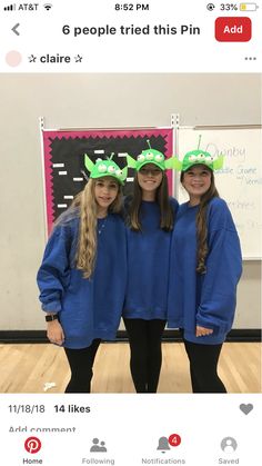 three girls wearing green hats and blue sweaters