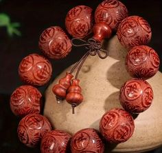 Enhance your spiritual journey with this exquisite Hand-Carved Natural Sandalwood Buddha Beads Bracelet. Each bead is intricately crafted from high-quality, fragrant sandalwood, known for its calming properties and deep connection to meditation and mindfulness practices. This bracelet features 12 finely detailed beads, each carved with traditional Buddhist symbols, adding an extra layer of meaning to your spiritual practice. Whether you wear it during meditation, yoga, or as a daily reminder of Spiritual Wooden Beaded Bracelets, Handmade Wooden Beaded Bracelets For Meditation, Spiritual Carved Beaded Bracelets, Spiritual Carved Beaded Bracelets, Adjustable, Spiritual Wood Round Beads Jewelry, Adjustable Carved Beaded Spiritual Bracelets, Traditional Wooden Bracelets With Round Beads, Traditional Wooden Bracelet With Round Beads, Traditional Wood Bracelets With Round Beads