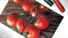 some red tomatoes on a branch with water droplets and a green crayon pencil