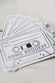 three stickers with the words song request printed on them, sitting next to each other