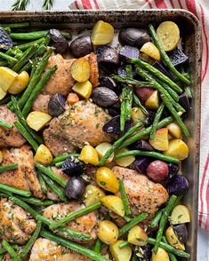 a pan filled with chicken, potatoes and green beans