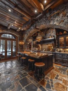 a large kitchen with stone walls and an island