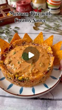 mexican rice with creamy sauce and tortilla chips on a plate in front of the camera