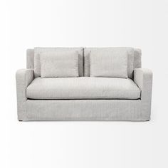 a white couch sitting on top of a wooden floor