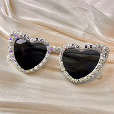 💖💖 Step into the enchanting world of our meticulously crafted heart-shaped sunglasses, where passion meets precision in every detail. Adorned with exquisite pearl embellishments, these sunglasses are a testament to artisanal artistry, perfect for your bridal ensemble. 💍💍 Elevate your bridal style effortlessly with these stunning sunglasses, designed to enhance your special moments. Whether it's your wedding day, honeymoon, bridal shower, or bachelorette party, let these shades add a touch of White Heart-shaped Sunglasses For Beach, Heart-shaped Glass Sunglasses For Gift, Heart-shaped Glass Sunglasses As Gift, White Heart-shaped Sunglasses With Gradient Lenses, White Heart-shaped Beach Sunglasses, White Sunglasses With Gradient Lenses As Gift, White Sunglasses With Gradient Lenses As A Gift, Heart-shaped Sunglasses With Tinted Lenses For Gift, Heart-shaped Sunglasses With Tinted Lenses As Gift