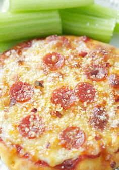 a pepperoni pizza and celery on a plate