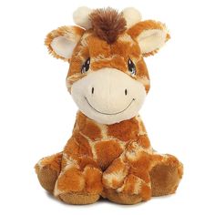 a stuffed giraffe sitting down with its eyes open