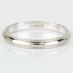 a white gold wedding ring on a white background