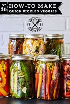 several jars filled with different types of vegetables