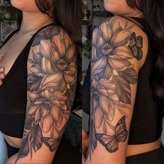 a woman's arm with flowers and butterflies on it, while she is wearing a black bra