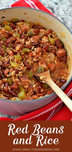 red beans and rice in a pot with a wooden spoon next to it on a red towel