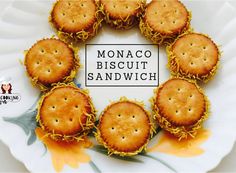 small crackers arranged on a white plate with the words monaco biscuit sandwich written across it