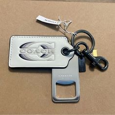 a key chain with a bottle opener attached to it and a card holder in the shape of a rectangle