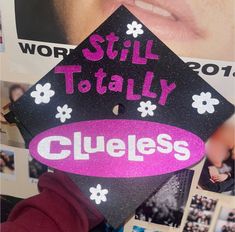 a graduation cap with the words still totally cleeless on it and photos behind it