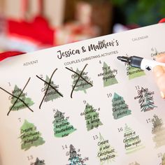 a person is writing on a christmas tree calendar