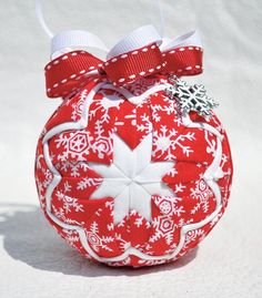 a red and white ornament with snowflakes on it's side