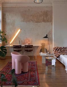 a living room filled with furniture next to a table and chairs on top of a wooden floor