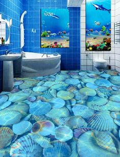 a bathroom with blue walls and flooring that has seashells on it