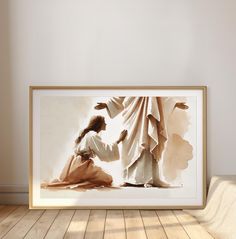 a framed photograph of jesus and the woman clothed in cloths, on a wooden floor