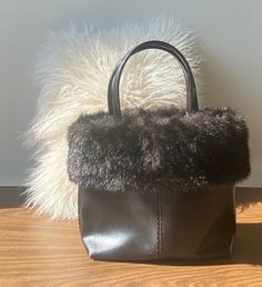 Vintage Esprit Top Handle Dark Brown Faux Fur Handbag in PVC * 2000's Y2K * 1960's Style * Mini Bag * Magnet Snap Closure * Small Bucket Bag Vintage Esprit dark brown mini bucket bag in pvc with removable fur piece.  Top handle and flat bottom, has natural structure. Has a zippered inside pocket and snap closure. Measurements : Height : Width : Depth : Good condition. Some wear due to age, PVC has some discolouration and cracking. Interior is clean. Sourced in Canada 🇨🇦 Winter Shopping Top Handle Bag, Rectangular Shoulder Bag For Winter Evenings, Winter Evening Rectangular Shoulder Bag, Vintage Bucket Bag With Detachable Handle, Winter Evening Bag With Top Handle, Black Handheld Bag For Winter, Winter Black Handheld Bag, Winter Leather Shopping Bags, Leather Evening Bags For Winter