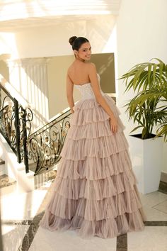 a woman in a dress standing on stairs