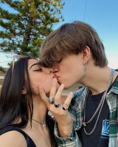 a young man and woman kissing each other