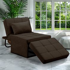 a brown reclining chair sitting next to a window in a room with white walls