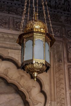 an ornate light fixture hanging from the ceiling