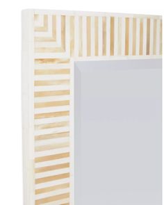 a mirror that is made out of wood and has stripes on the side of it