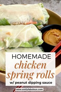 homemade chicken spring rolls with peanut dipping sauce in a bowl on the table next to chopsticks