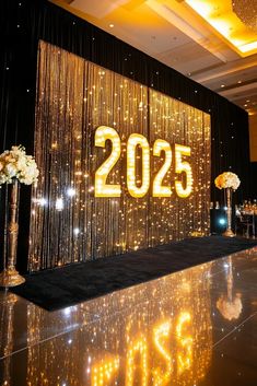 a large stage set up for a party with lights and flowers on the dance floor