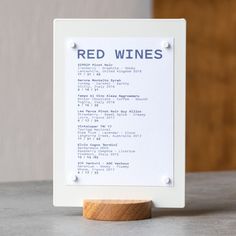 a red wine sign sitting on top of a table