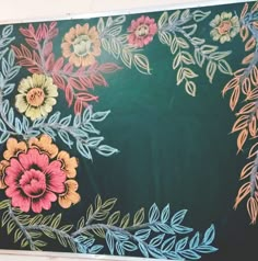 a painting with flowers and leaves painted on it