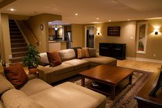 a living room filled with furniture and a flat screen tv mounted to the side of a wall