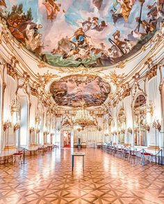 an ornately decorated room with chandeliers and paintings on the ceiling is shown