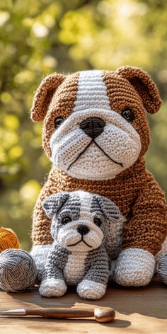 there is a crocheted dog and a puppy sitting next to each other