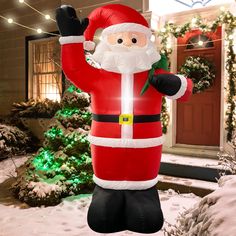 an inflatable santa clause is standing outside