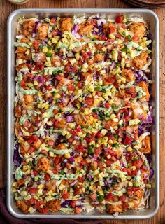 a casserole dish filled with chicken, vegetables and dressing on a wooden table