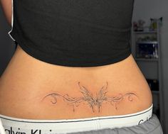 a woman with a butterfly tattoo on her stomach