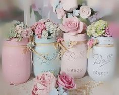 there are many jars with flowers in them