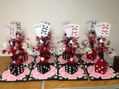 a table topped with cards and vases filled with flowers