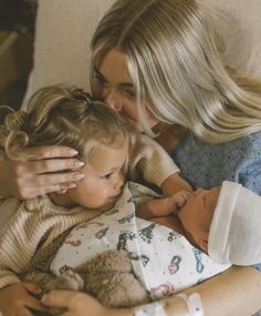 a woman holding a baby in her arms