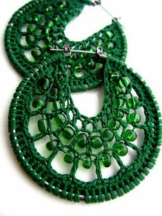 a pair of green beaded hoop earrings