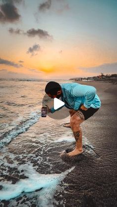 a man standing on top of a beach next to the ocean