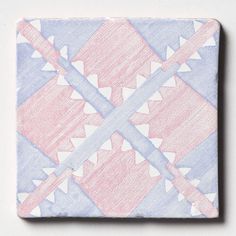 a pink and blue square tile with arrows on it