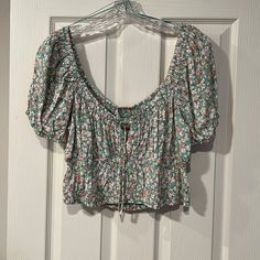 Adorable Crop Top In Green Floral. Stretch Around The Neck, Sleeves And Waist. Tie Front. Tag Is Falling Off On One Side. Casual Floral Print Crop Top For Day Out, Casual Cropped Floral Print Tops, Green Floral Print Casual Crop Top, Casual Floral Print Crop Top Blouse, Casual Green Floral Print Crop Top, Casual Green Crop Top Blouse, Fashion Definition, Floral Puff Sleeve Top, Short Sleeve Flannel