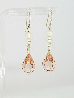 Elegant Pink Peach Swarovski Crystal Teardrop Briolette and White Freshwater Pearl Drop Dangle Earrings  DETAILS: Metal:               Ear wires are 14k Solid Yellow Gold, wire is high quality 14k gold fill Style:                Drop / Dangle Length:             45mm/ 1 3/4" Total Weight:    3.34 grams Sone Details: Swarovski Briolette: 12.5x8mm Pearl: 4mm   Shipped with USPS First Class Package. We describe everything to the best of our knowledge, please look closely at all pictures as they are part on the description and photos are enlarged for clarity. For any questions, please feel free to contact us through eBay's "Ask Seller a Question" link at the bottom of the listing.  We are more than happy to answer all of your questions and we are looking forward to receiving your feedback. Elegant Drop Pearl Earrings, Pearl Briolette Earrings, Gold Briolette Pearl Earrings, Gold Briolette Earrings With Dangling Beads, Pink Briolette Earrings As Gift, Pink Briolette Earrings For Gift, Citrine Drop Earrings, Wire Jewelry Patterns, Beads Craft Jewelry