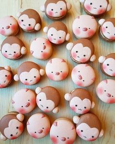 there are many pink and brown cupcakes that have monkeys on them with faces